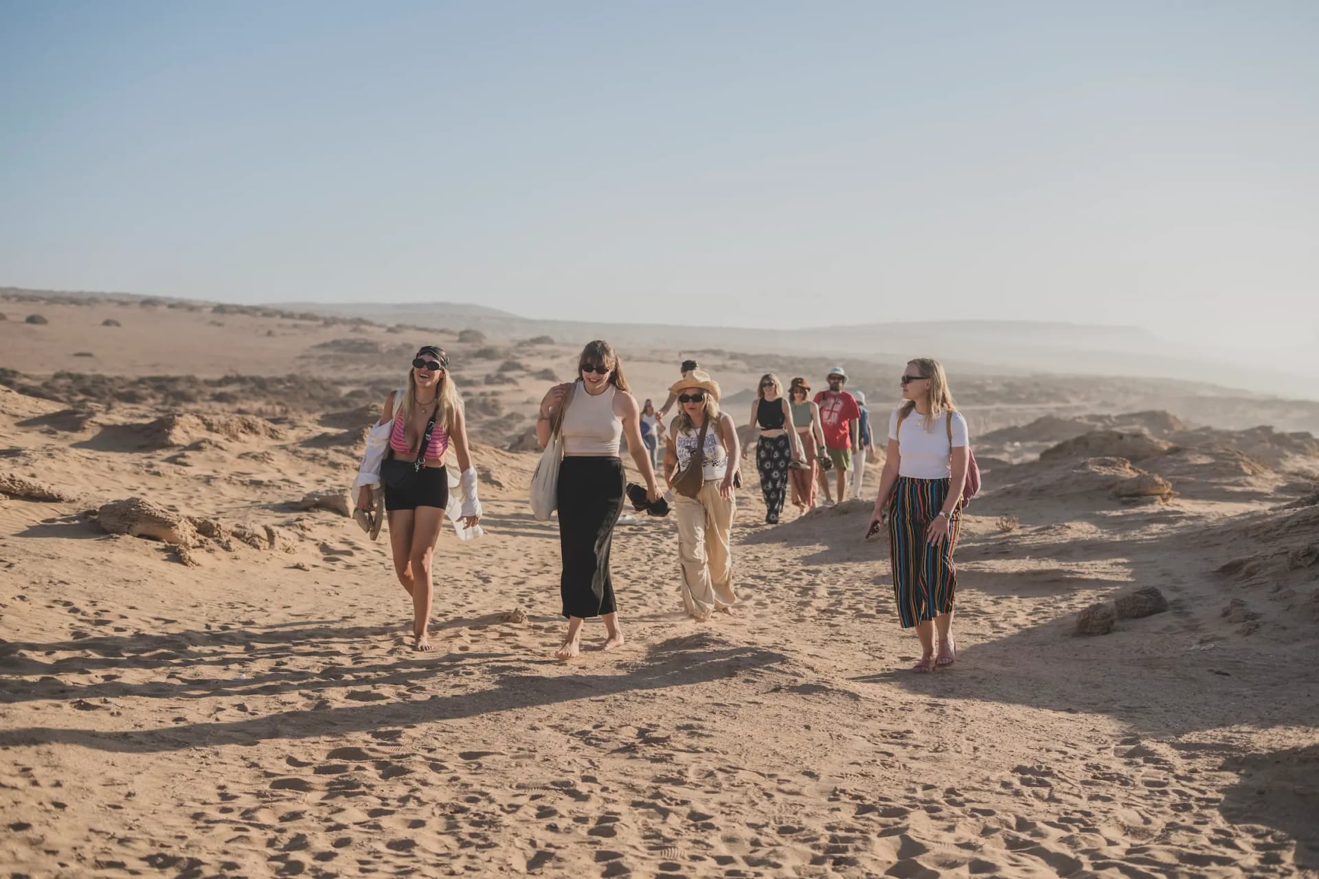 Girls walking in the sand dunes